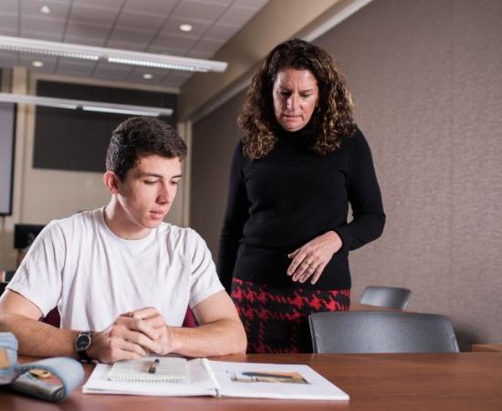 Teacher helping college student